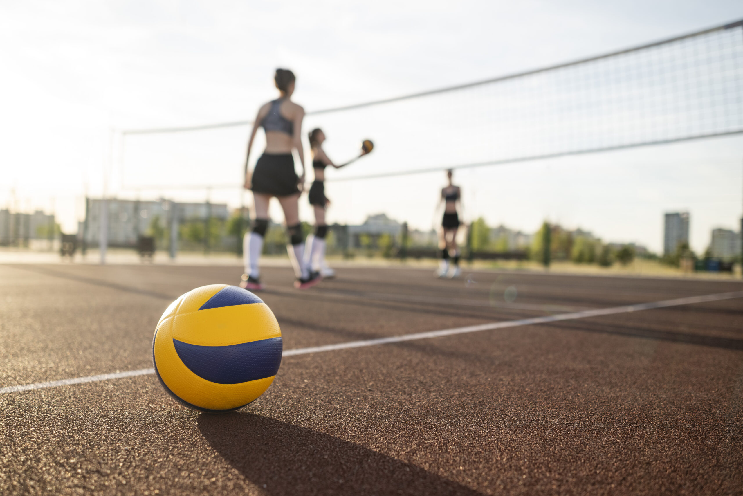 girls playing volleyball scaled